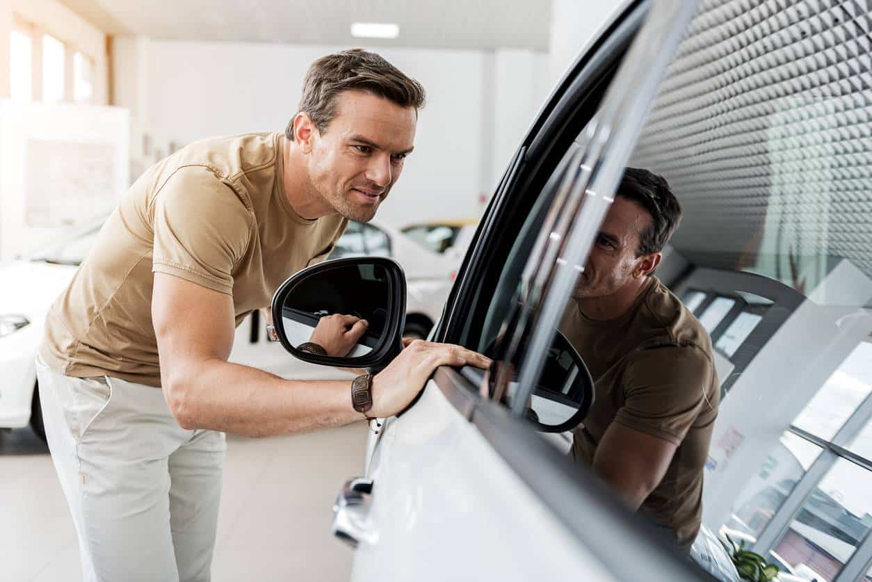 A man choosing a new car to order at a car dealership