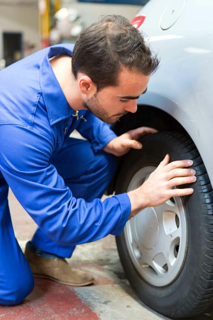 Specialist inspects a car tire